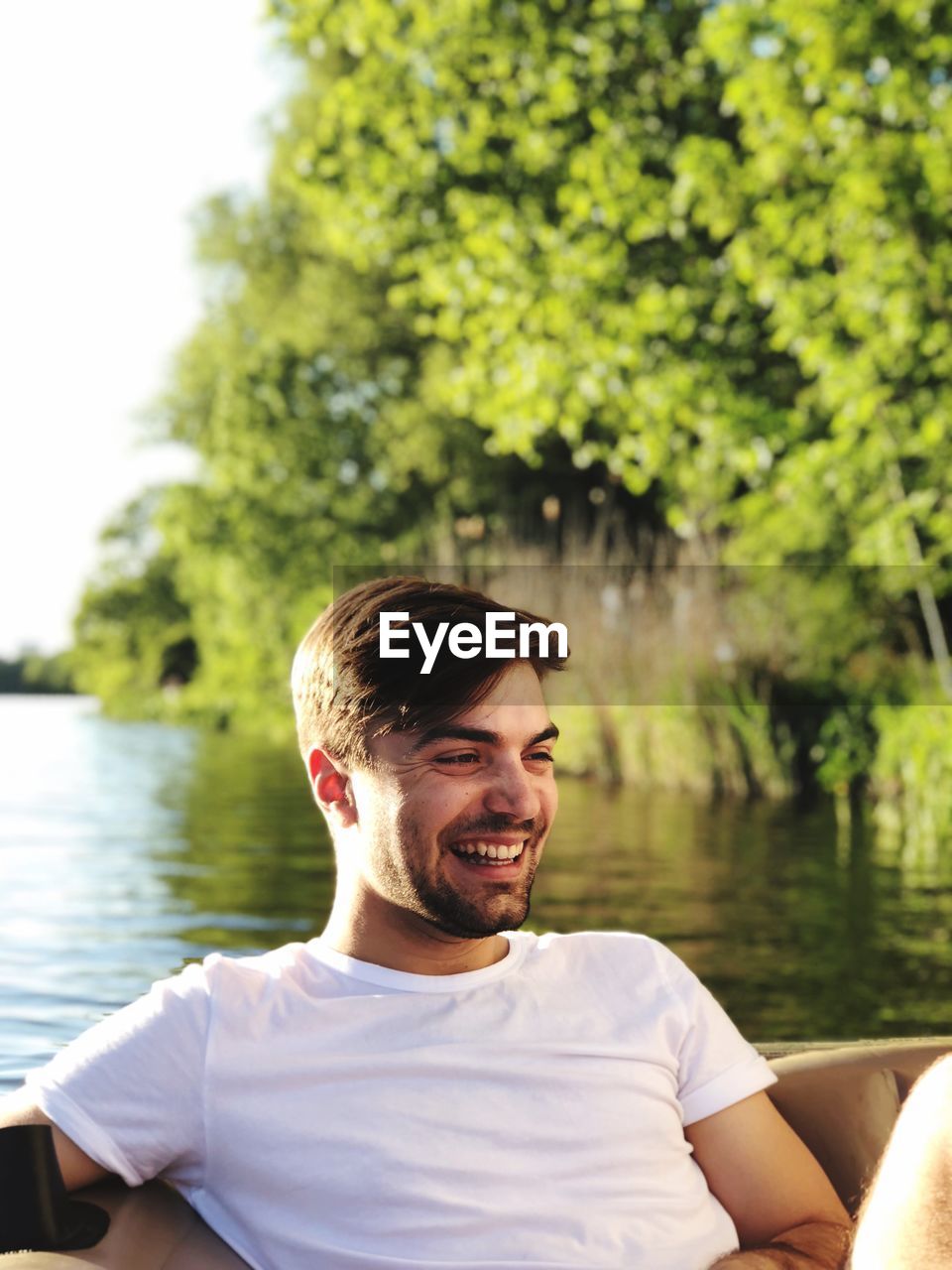 Smiling man boating on lake