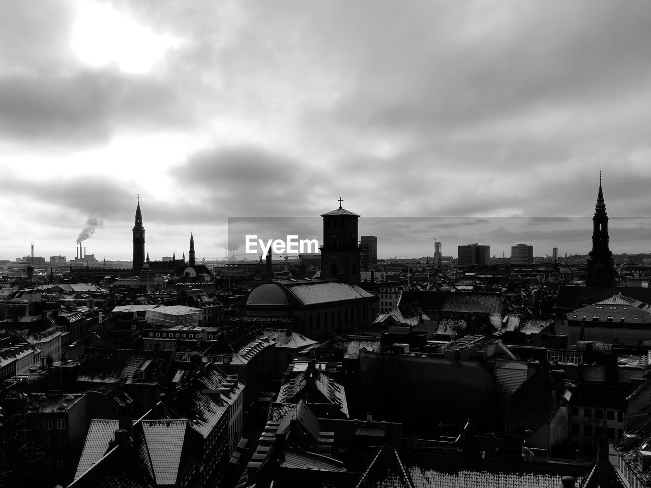 VIEW OF CITYSCAPE AGAINST CLOUDY SKY