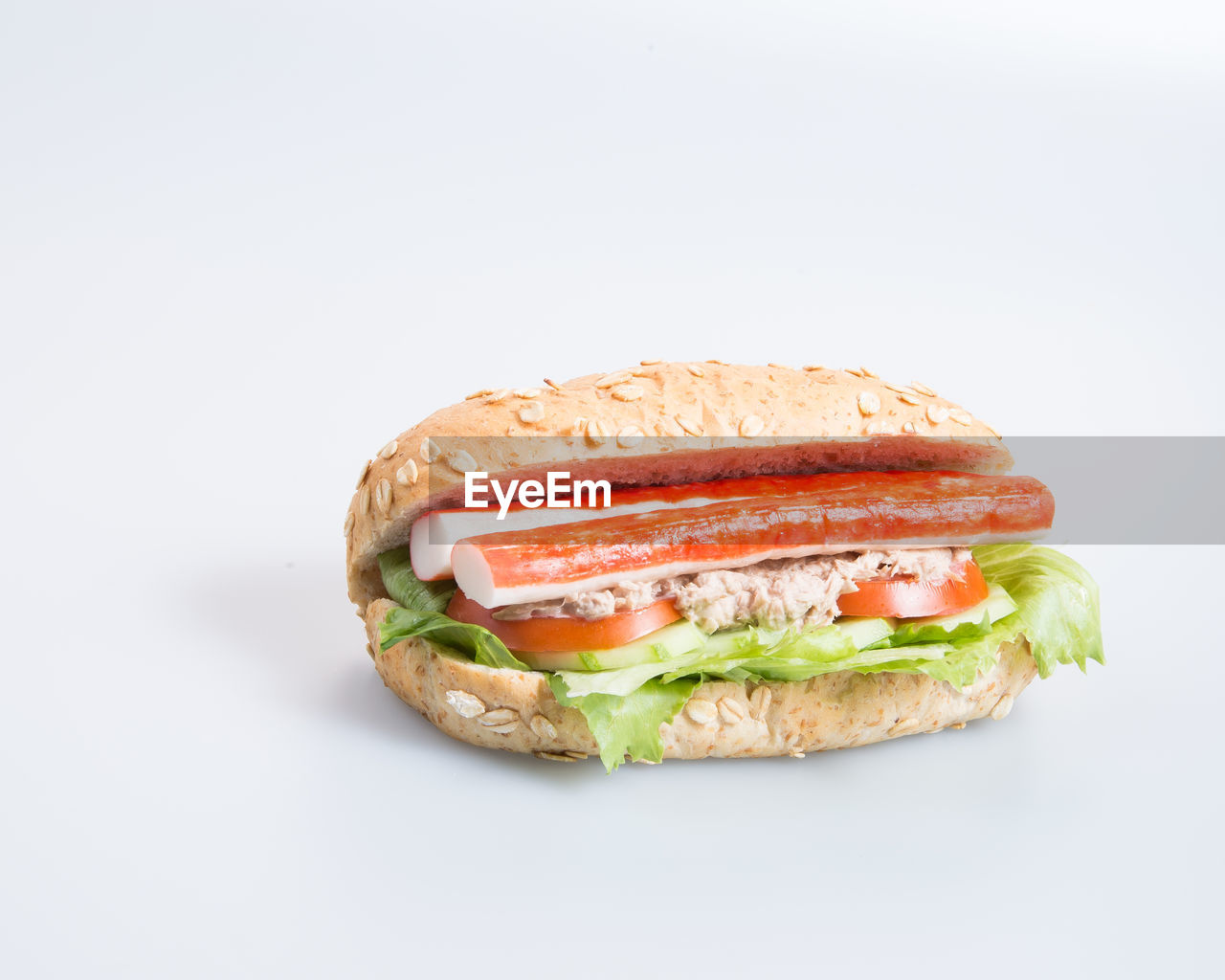 CLOSE-UP OF BREAD OVER WHITE BACKGROUND