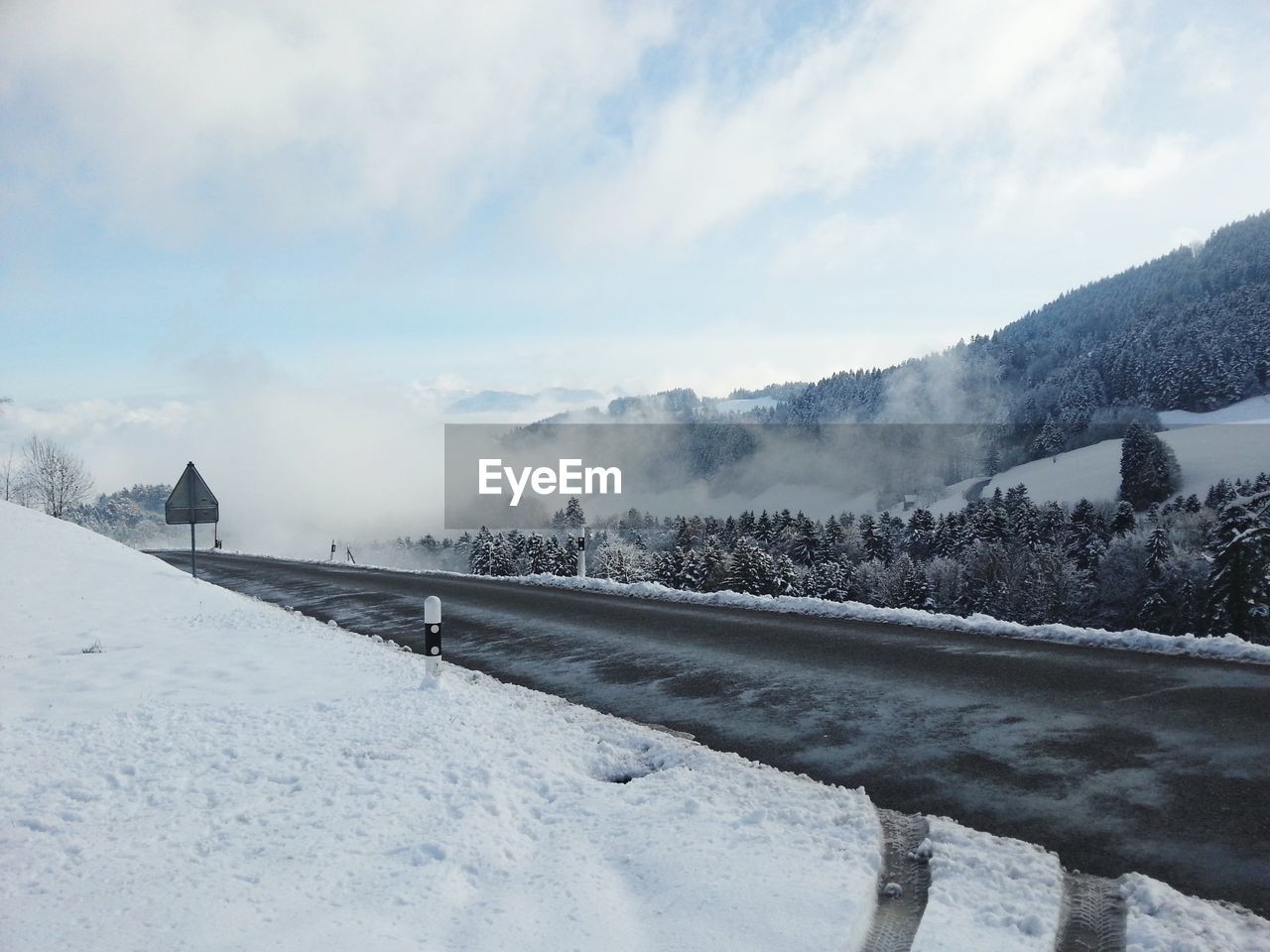 SNOW COVERED FIELD AGAINST SKY