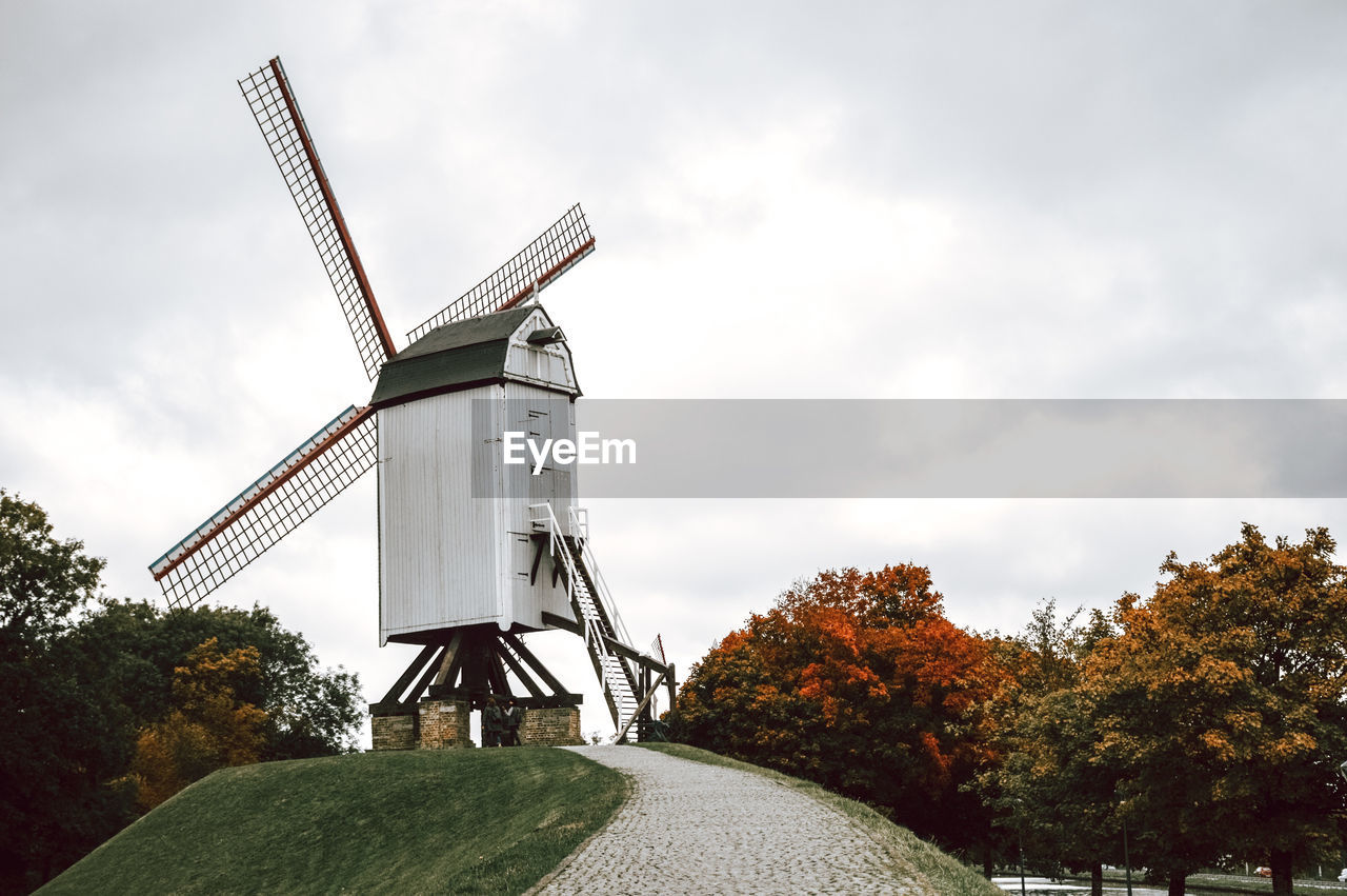 Low angle view of windmill against sky