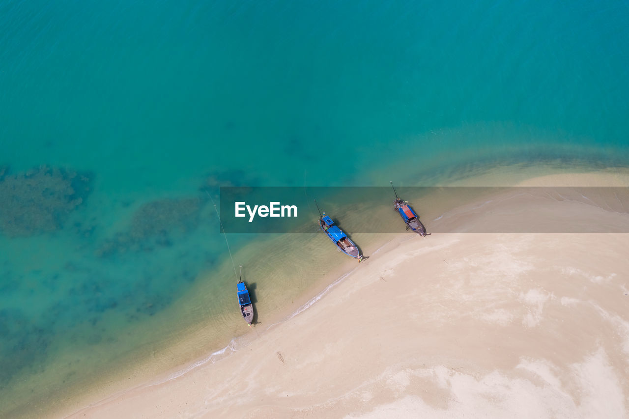 Long tail boat on the sand beach in island kra bi thailand aerial view