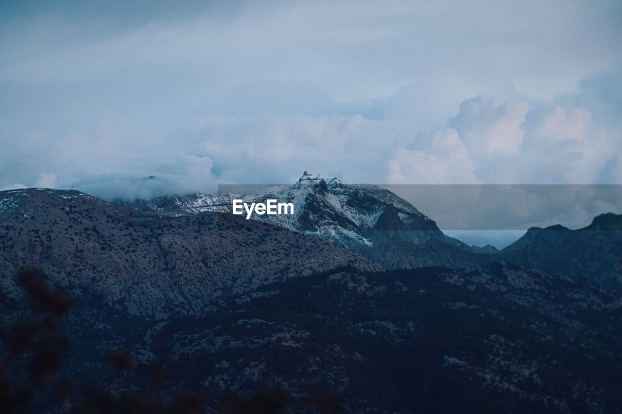 Scenic view of mountains against sky during winter