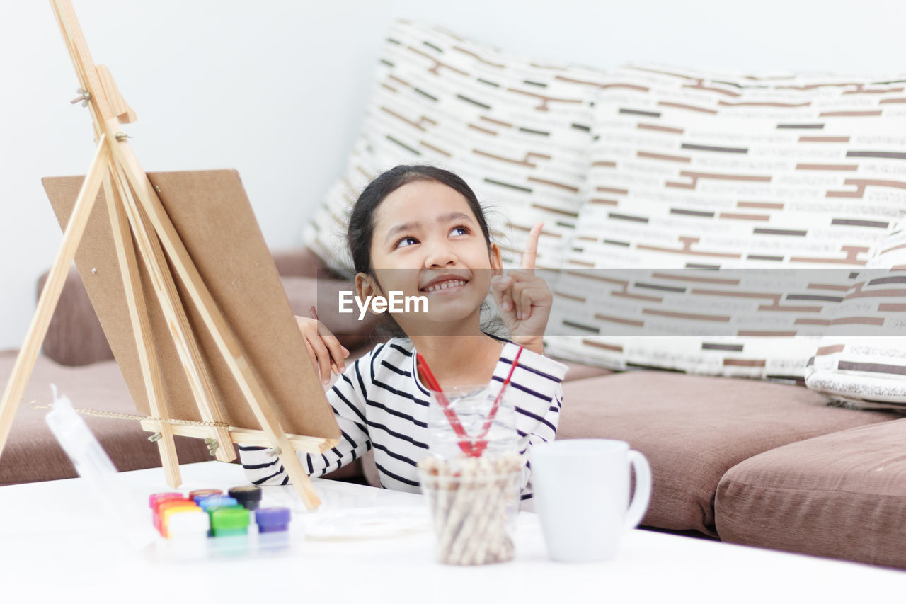 Girl painting on easel