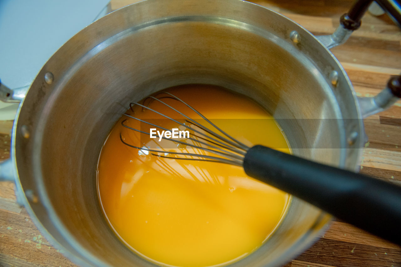 food, food and drink, indoors, kitchen utensil, wood, household equipment, dish, baked, batter, produce, close-up, yellow, wire whisk, no people, high angle view, kitchen, freshness, dessert, bowl