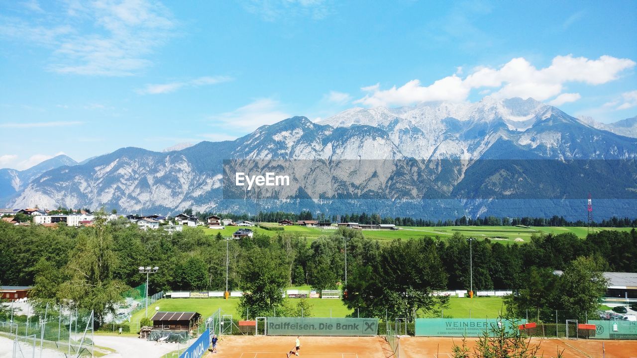 Scenic view of trees and mountains against sky