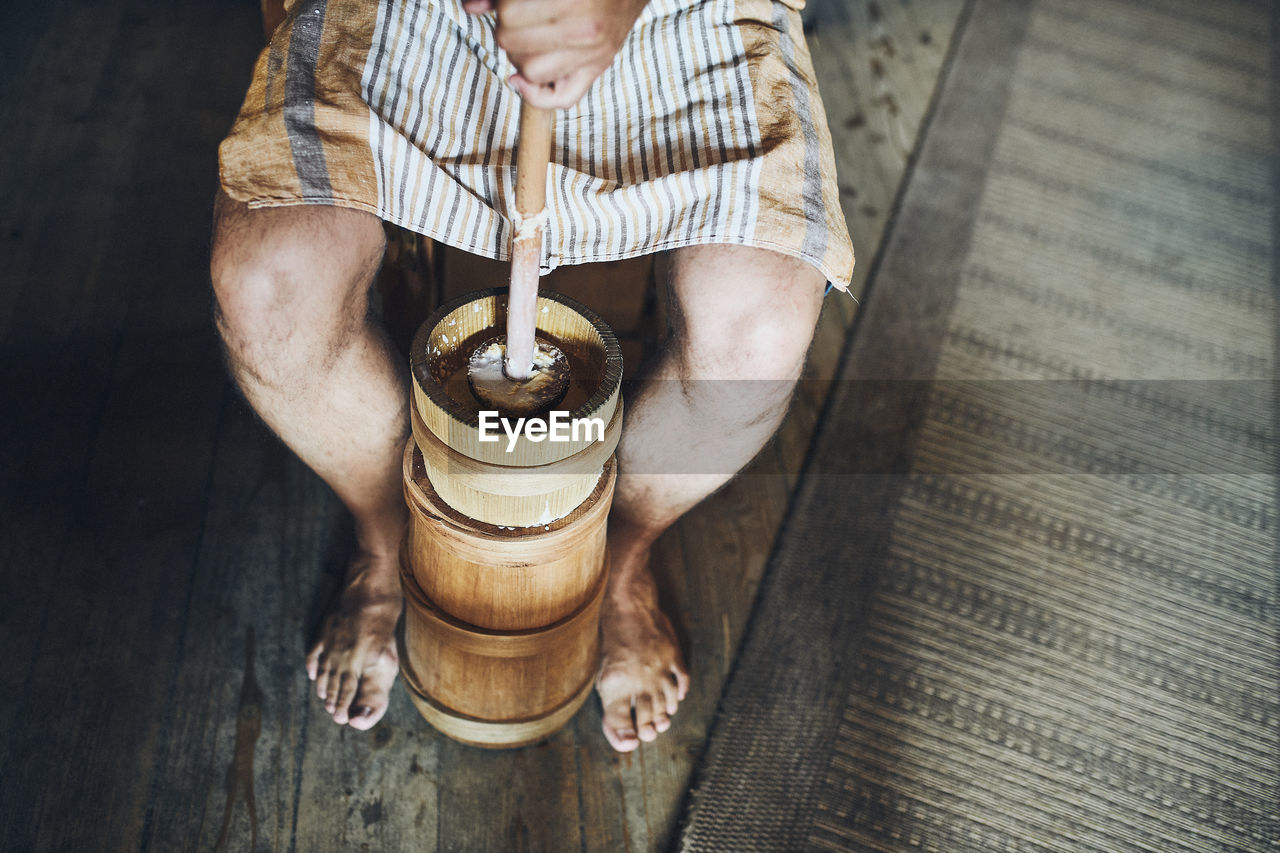 Man making butter with butter churn. old traditional method making of butter