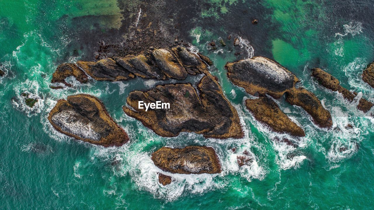 Aerial view of rock formations in sea