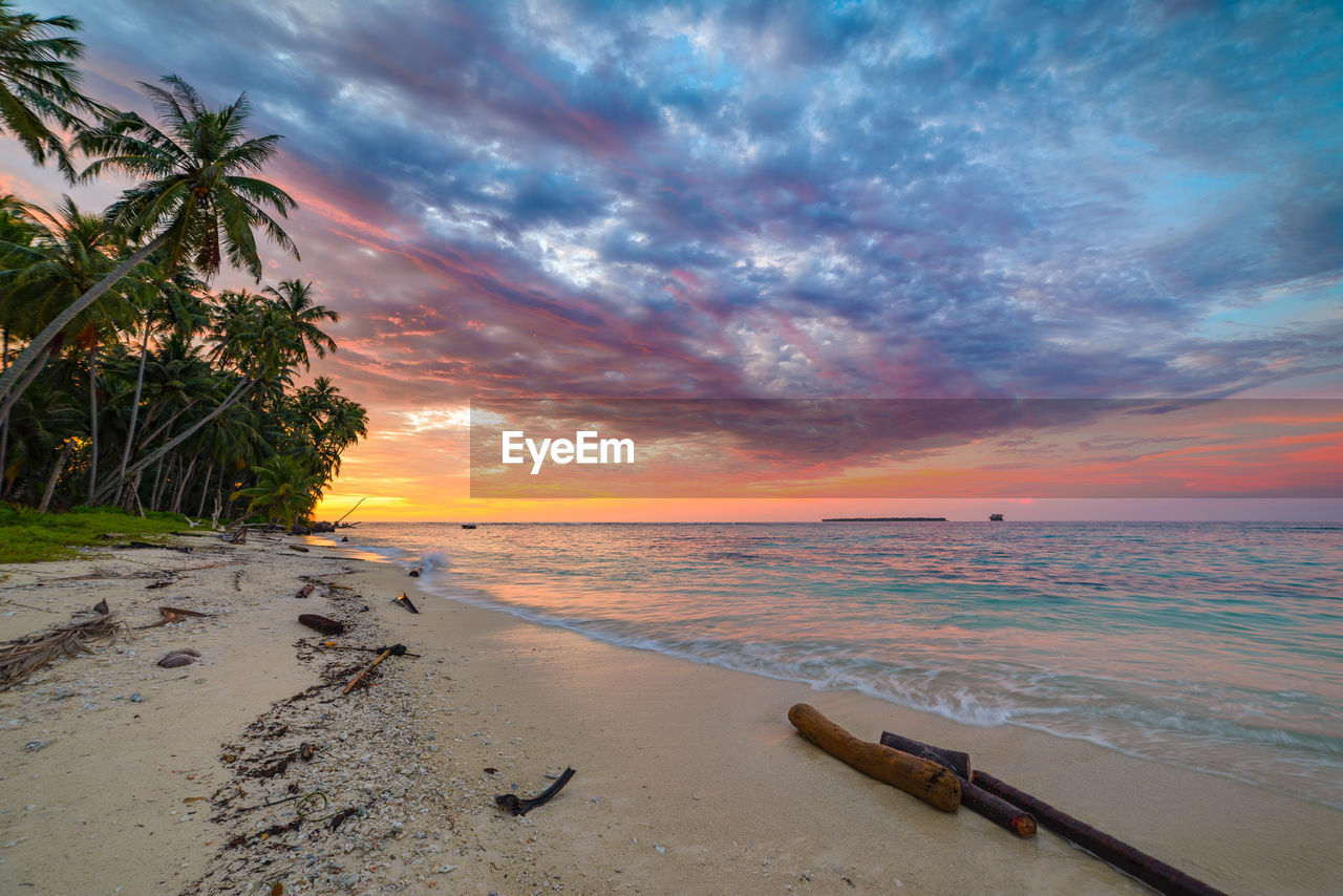 Scenic view of beach against sky during sunset