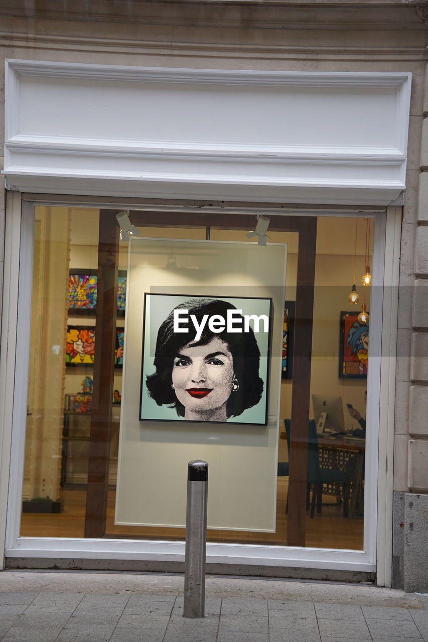 PORTRAIT OF MAN ON GLASS WINDOW