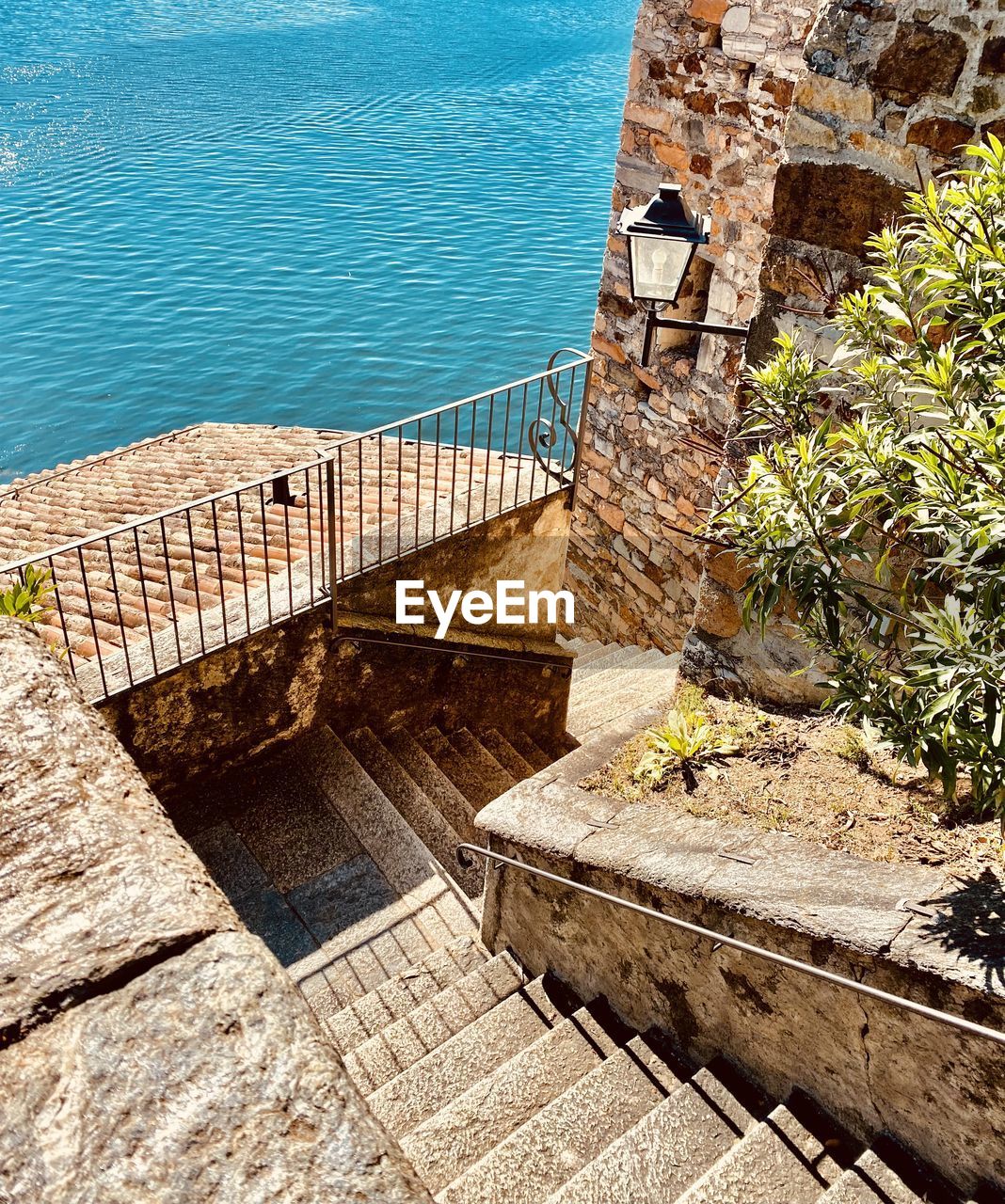 HIGH ANGLE VIEW OF STAIRCASE BY SEA