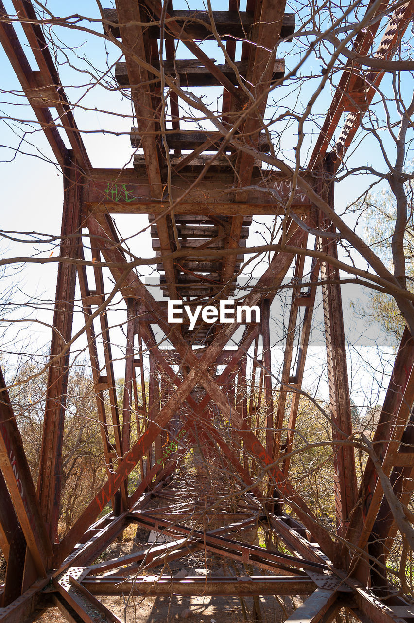 Low angle view of abandoned railway bridge on field