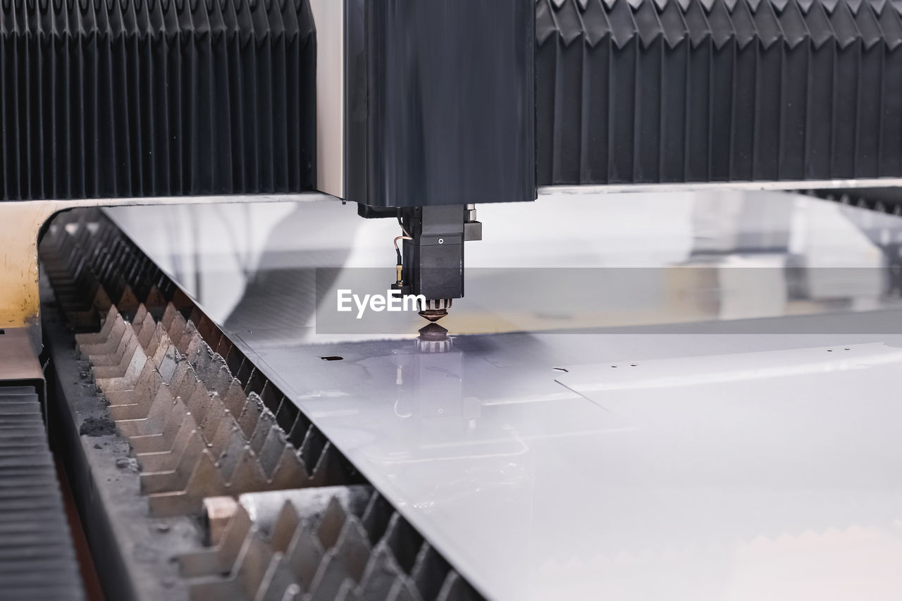 Scene close up, laser cutting machine cuts a metal plate. high-tech sheet metal production process