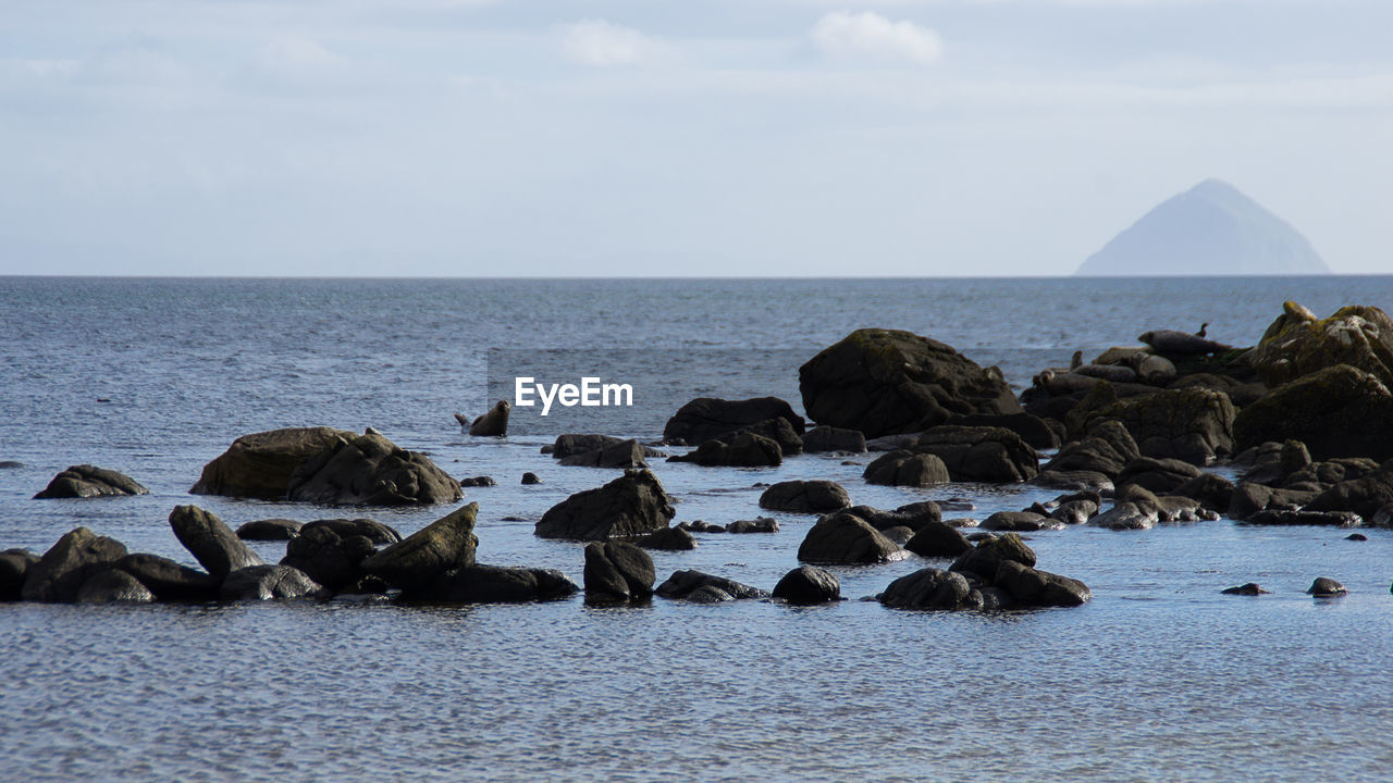 Rocks on shore against sky