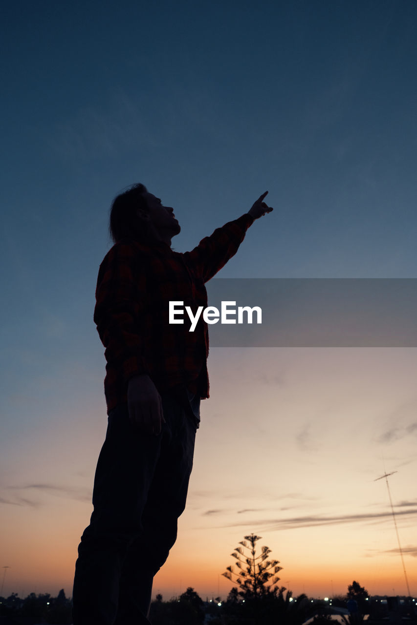 Man pointing up to the sky