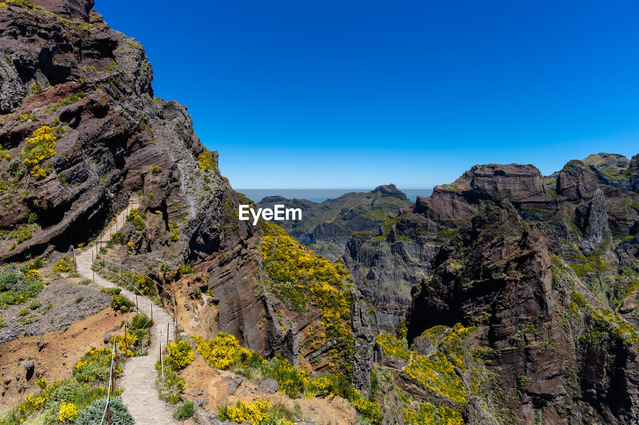 View of mountains against clear blue sky