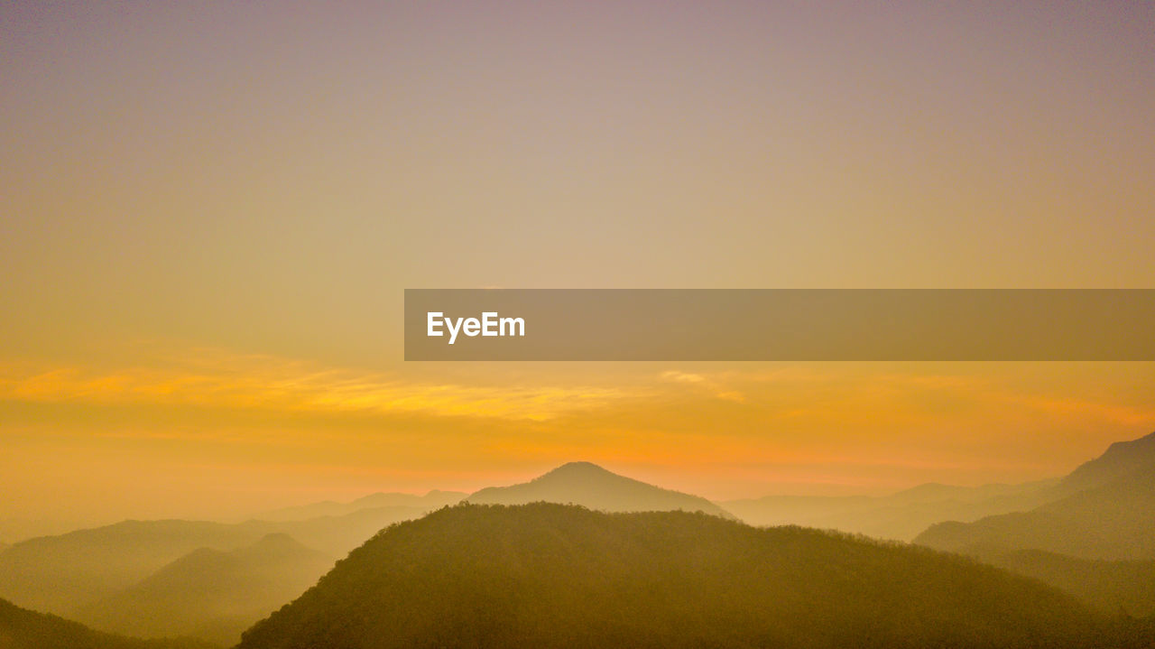 SCENIC VIEW OF SILHOUETTE MOUNTAIN AGAINST SKY DURING SUNSET