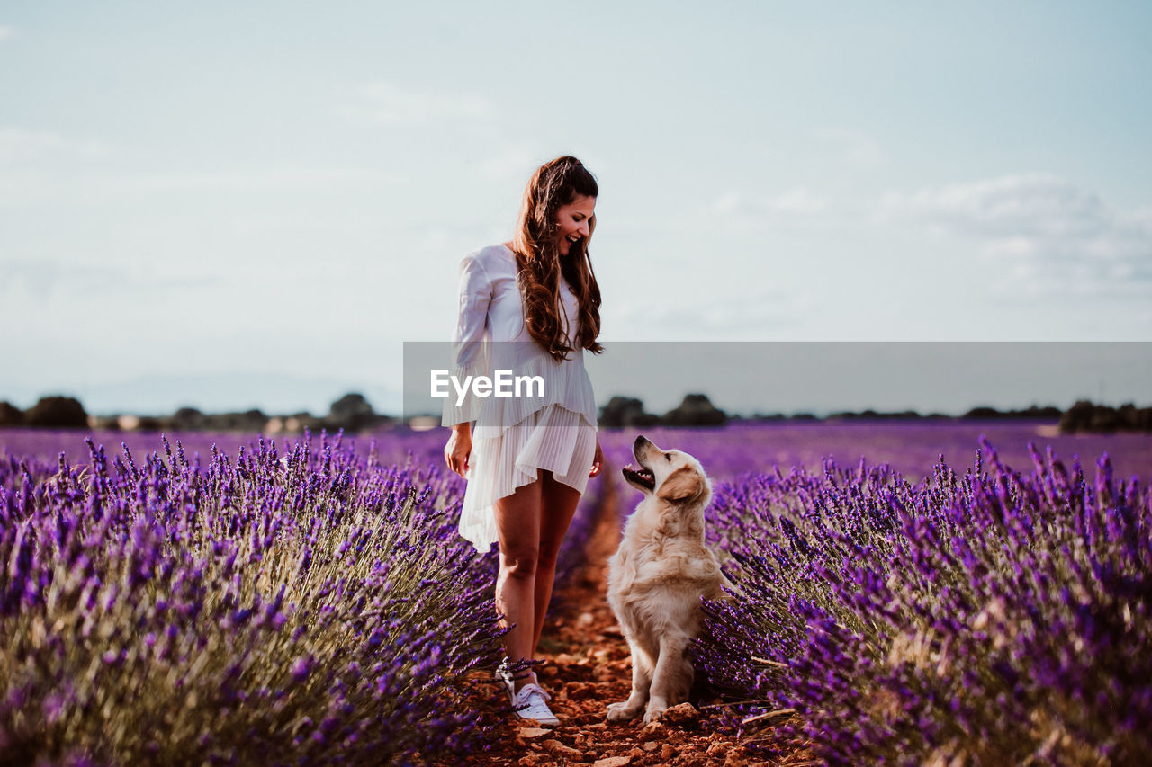 Woman with dog on lavender field