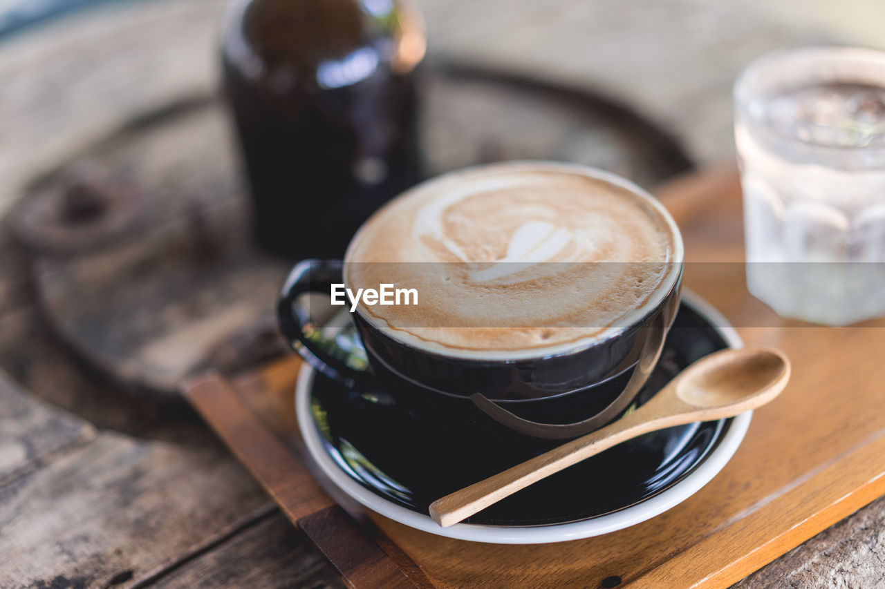 COFFEE CUP ON TABLE AT CAFE