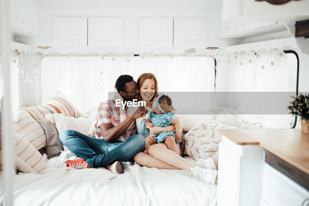 Cheerful family siting in camper van