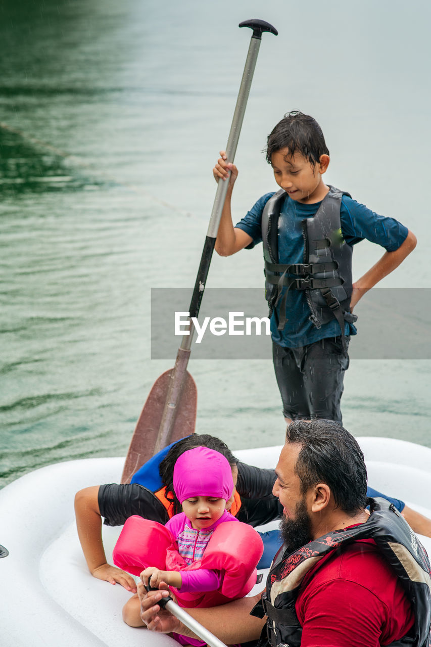 Family on pool raft over lake