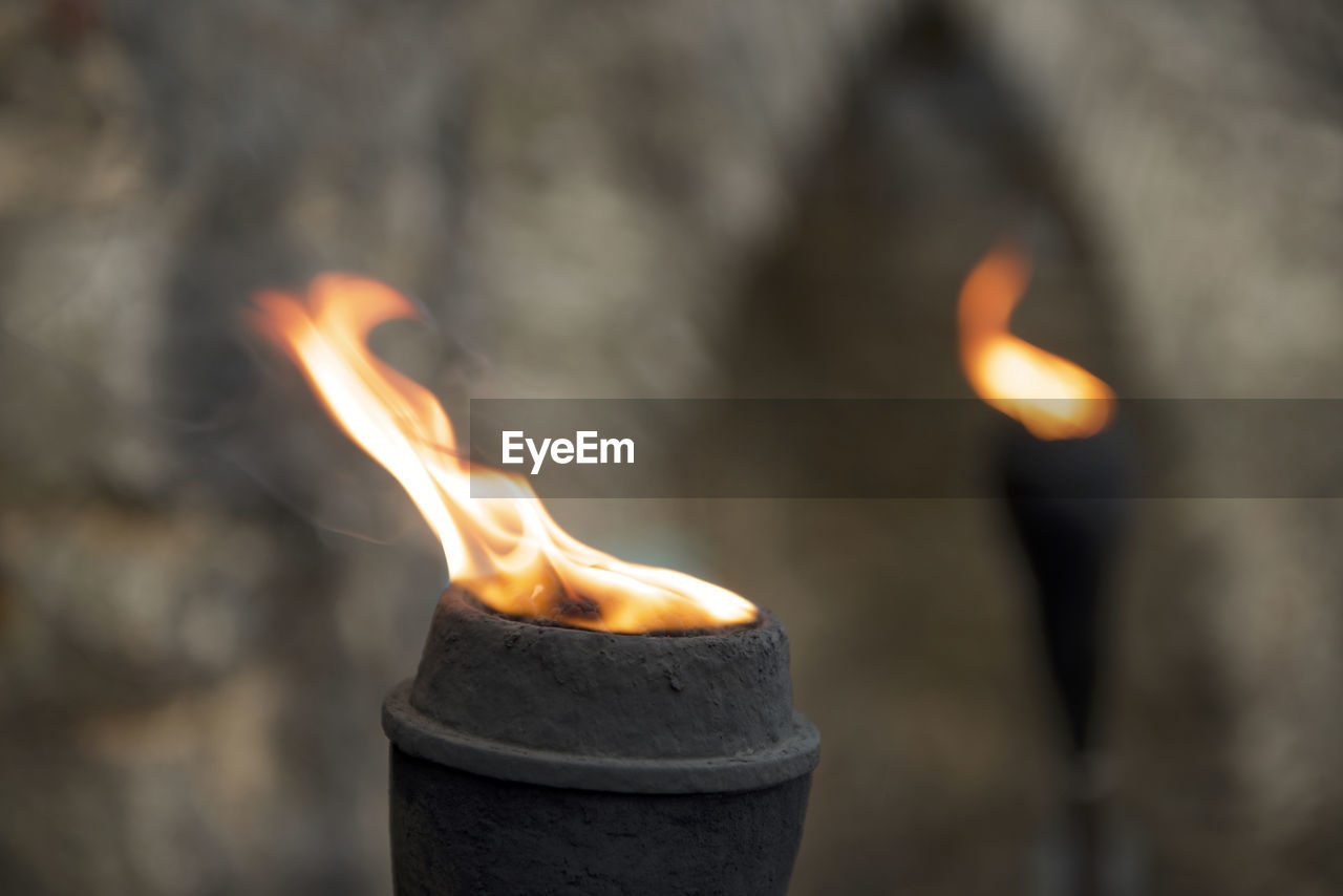 CLOSE-UP OF BURNING CANDLES