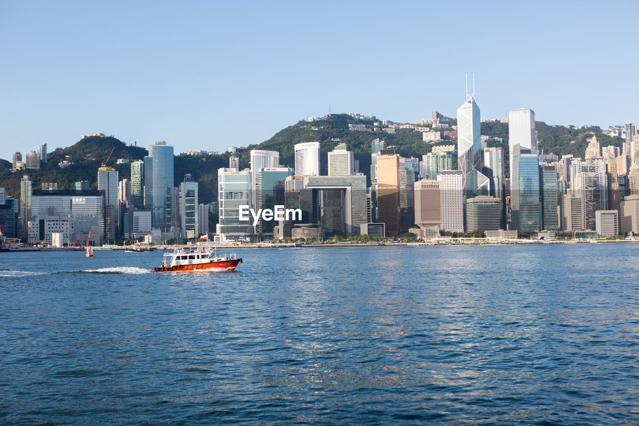 BOATS IN SEA AGAINST BUILDINGS