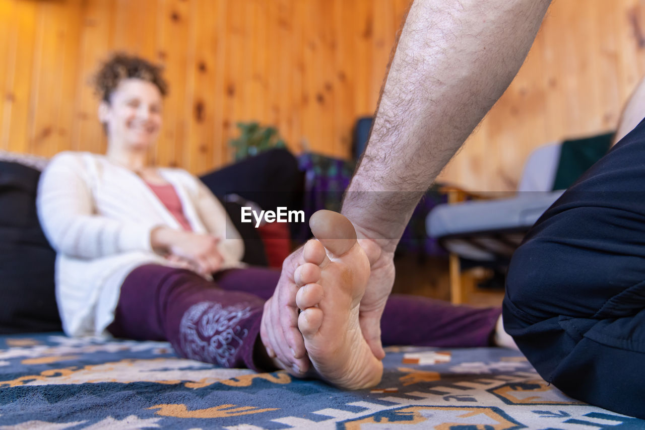 midsection of business people shaking hands on bed