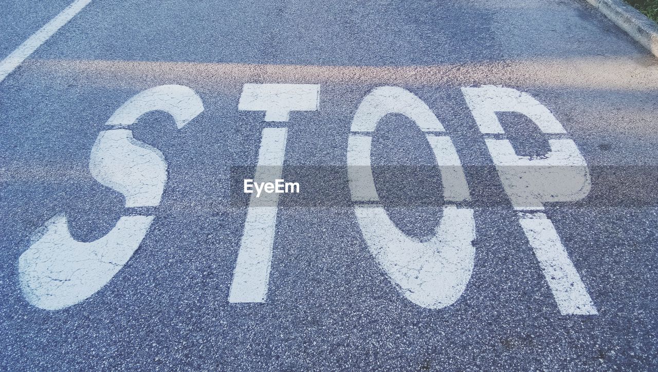 High angle view of arrow sign on road