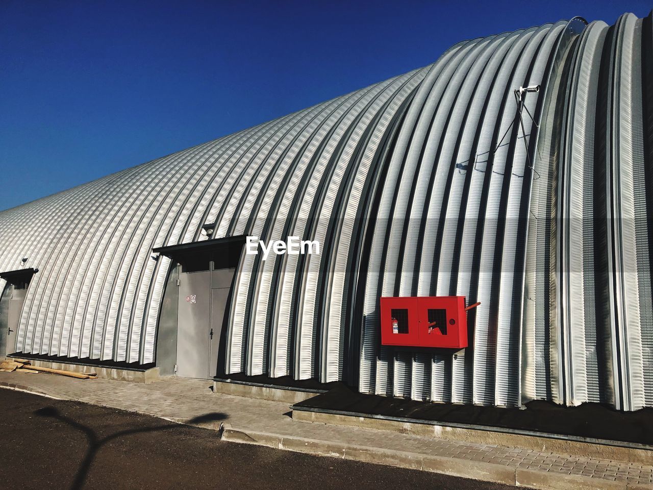 Corrugated iron structure against sky