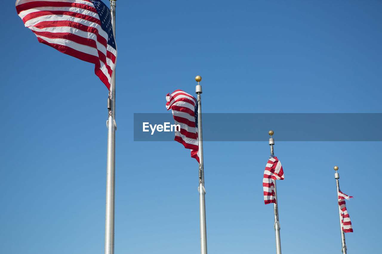 Low angle view of flags flag against clear sky