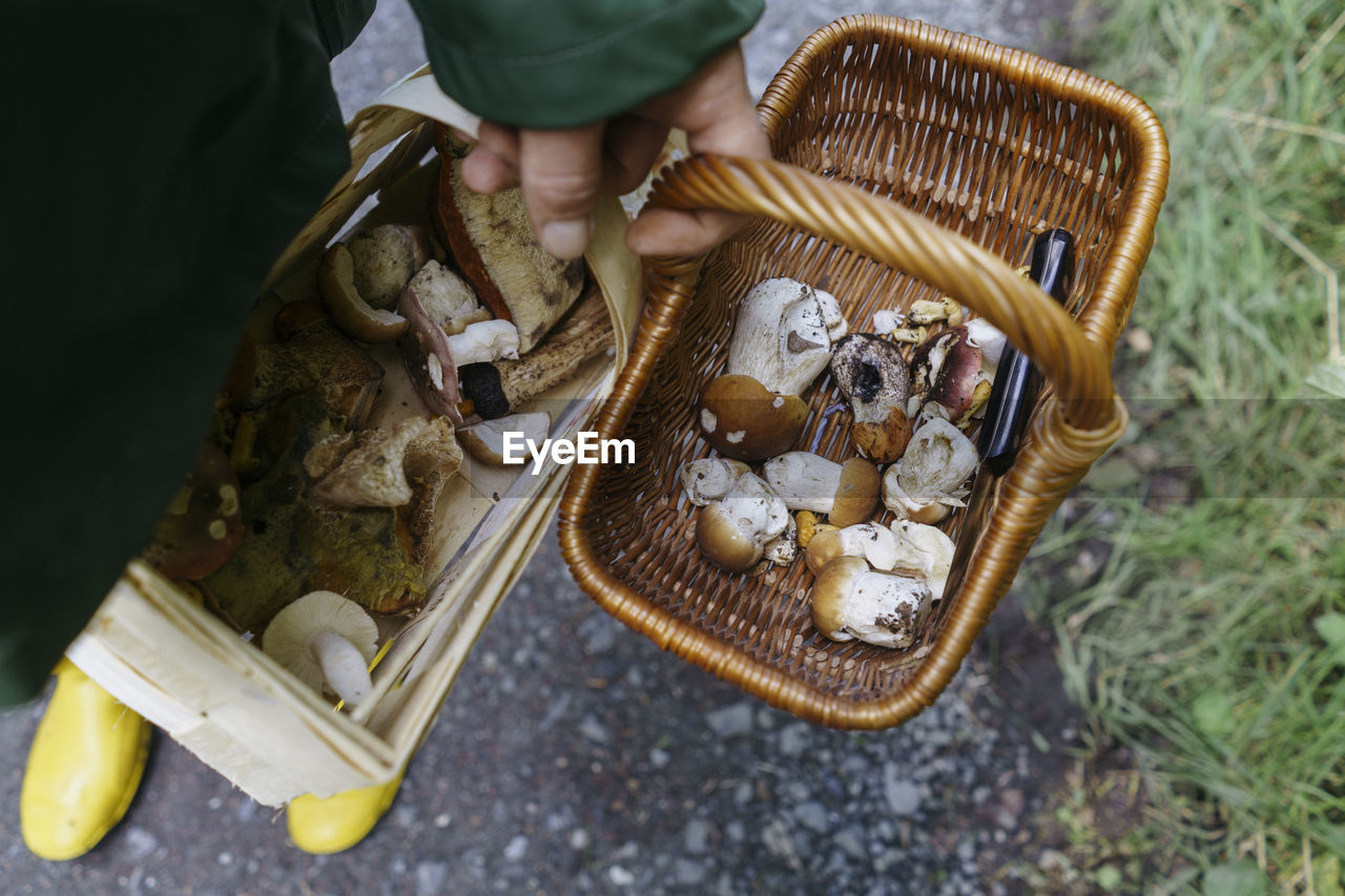 Man holding baskets of mushrooms