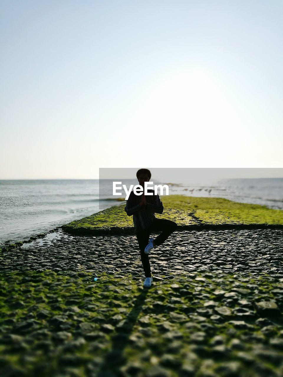 WOMAN STANDING ON BEACH