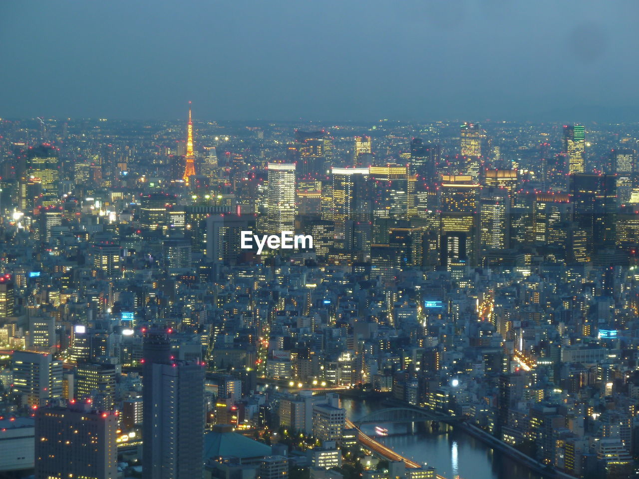 Illuminated cityscape against sky at night