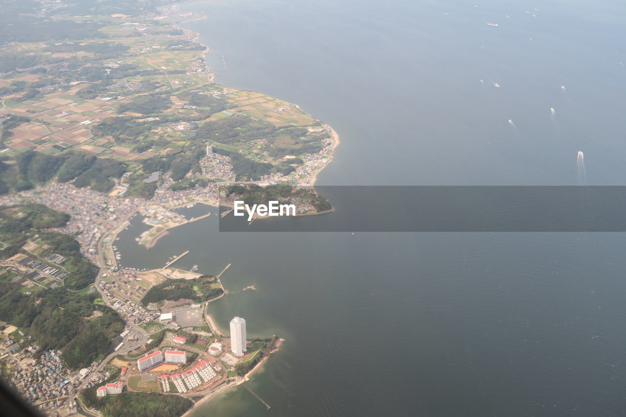 High angle view of buildings by sea