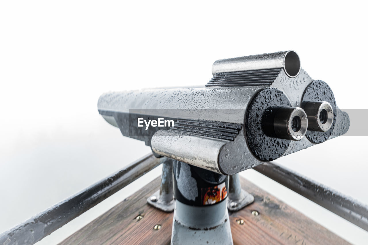 Close-up of coin-operated binoculars on pier