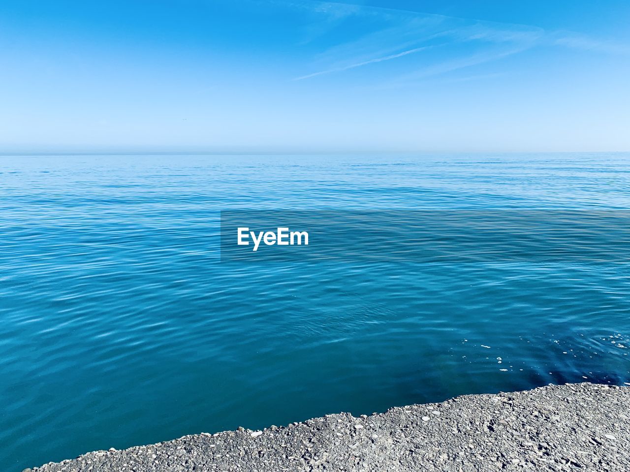 Scenic view of sea against blue sky