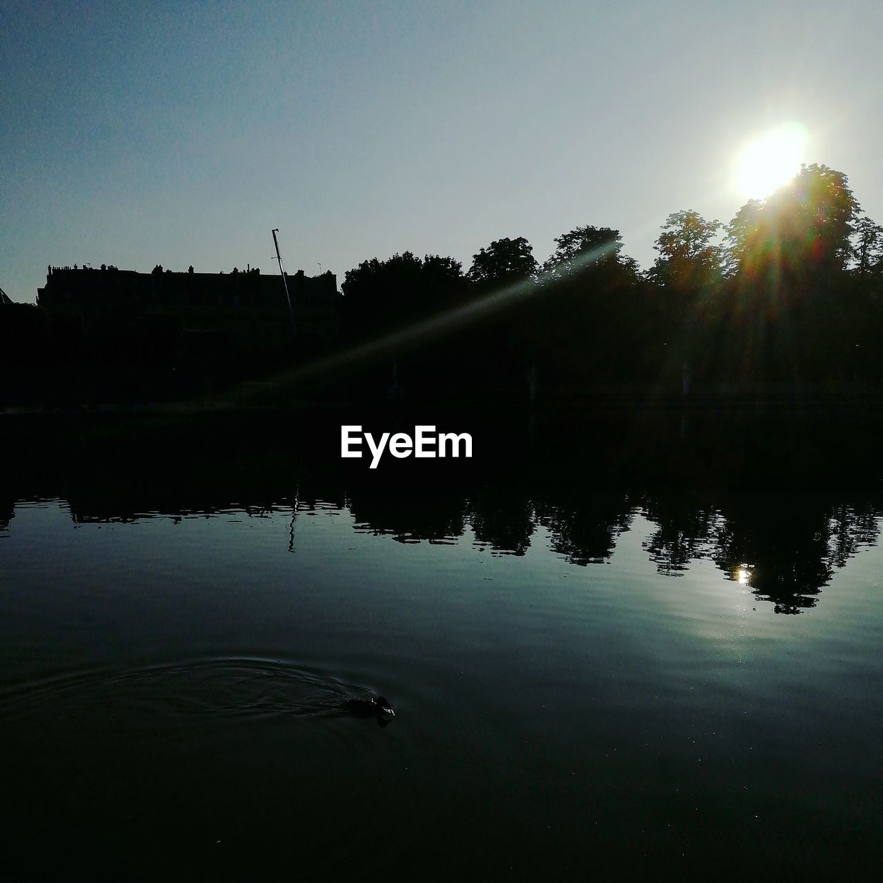 SCENIC VIEW OF LAKE AGAINST CLEAR SKY AT SUNSET