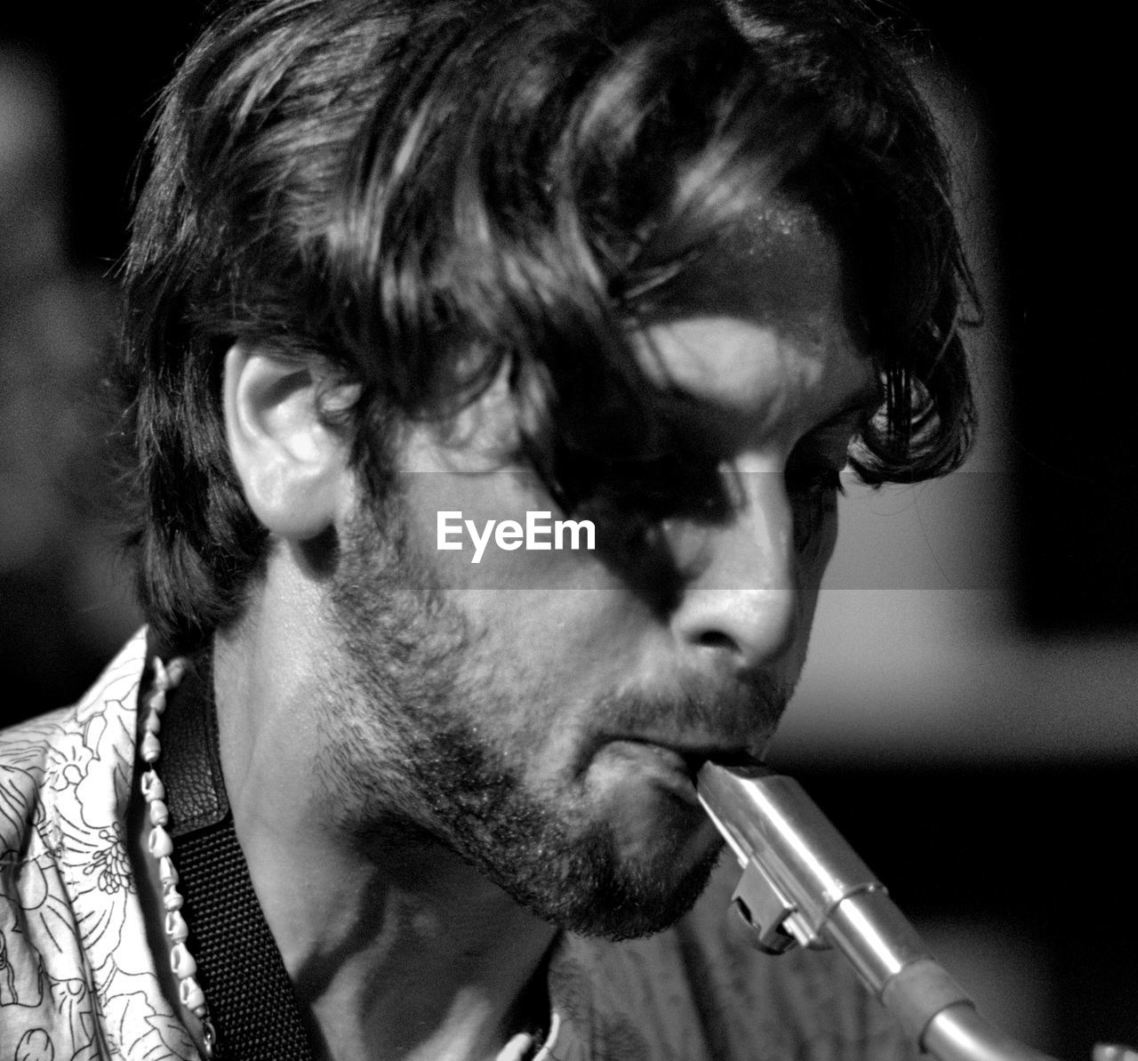 CLOSE-UP PORTRAIT OF YOUNG MAN WITH CIGARETTE