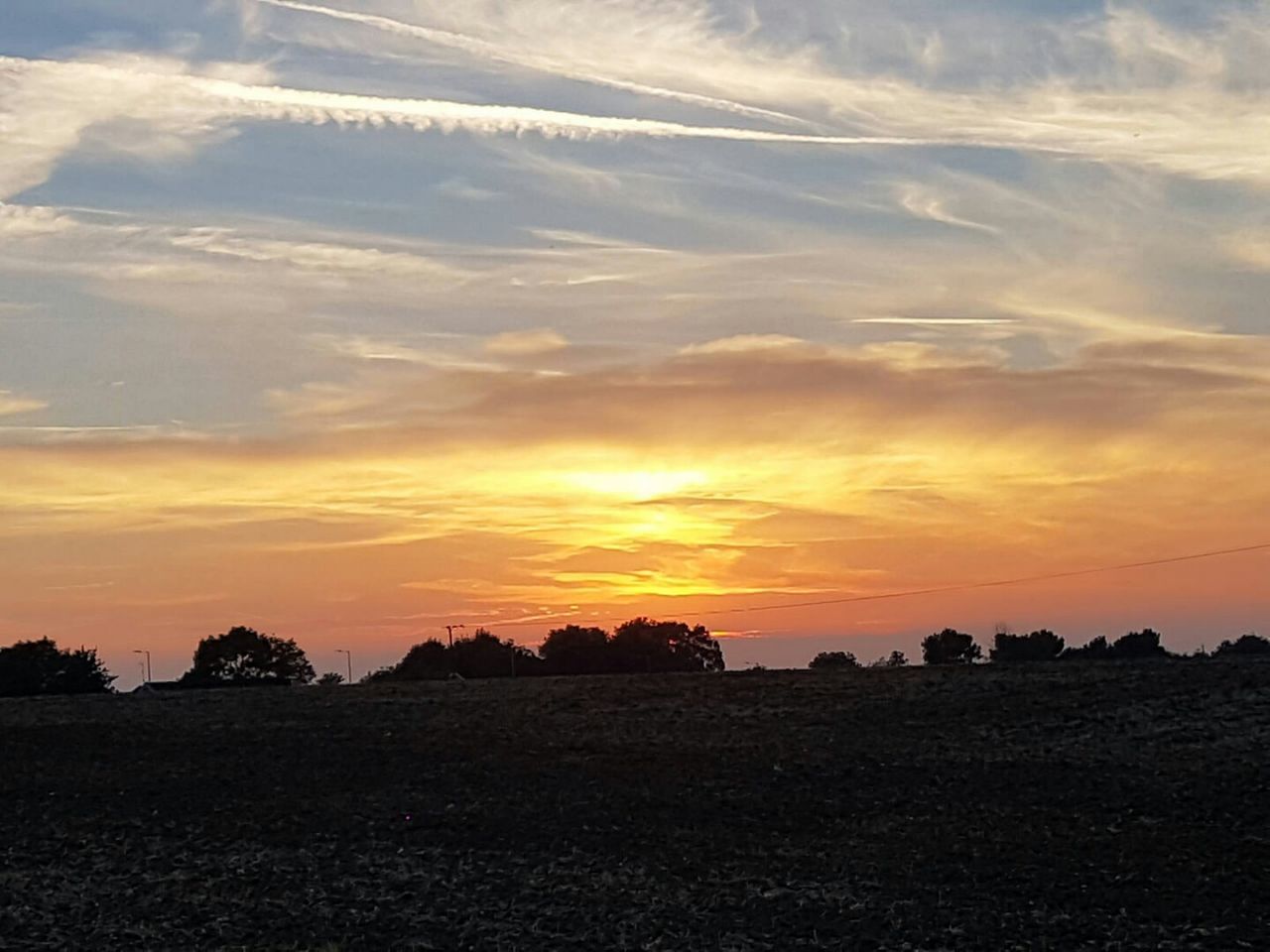 SCENIC VIEW OF DRAMATIC SKY OVER LANDSCAPE DURING SUNSET