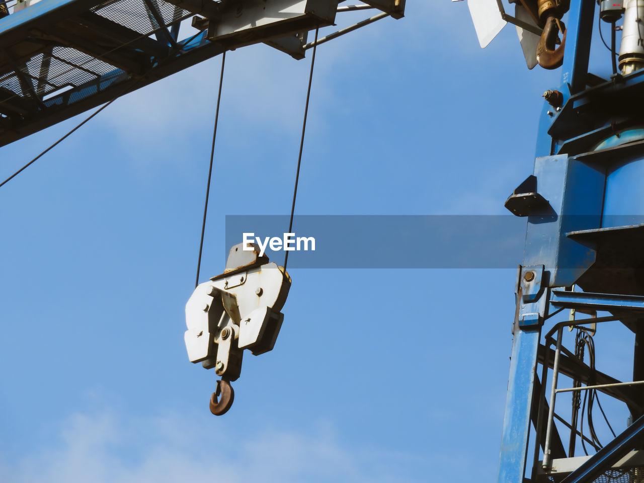 Low angle view of crane against sky