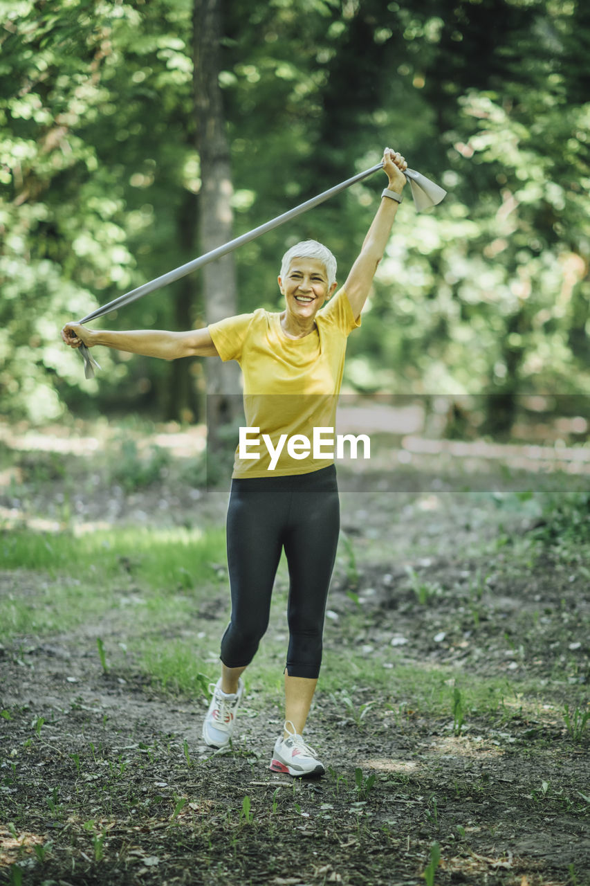 Resistance band walking exercise. mature woman doing strength workout with elastic resistance band
