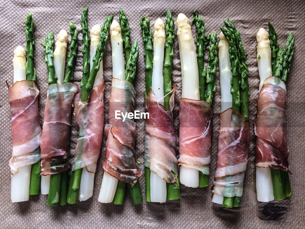 High angle view of asparagus rolled in bacon