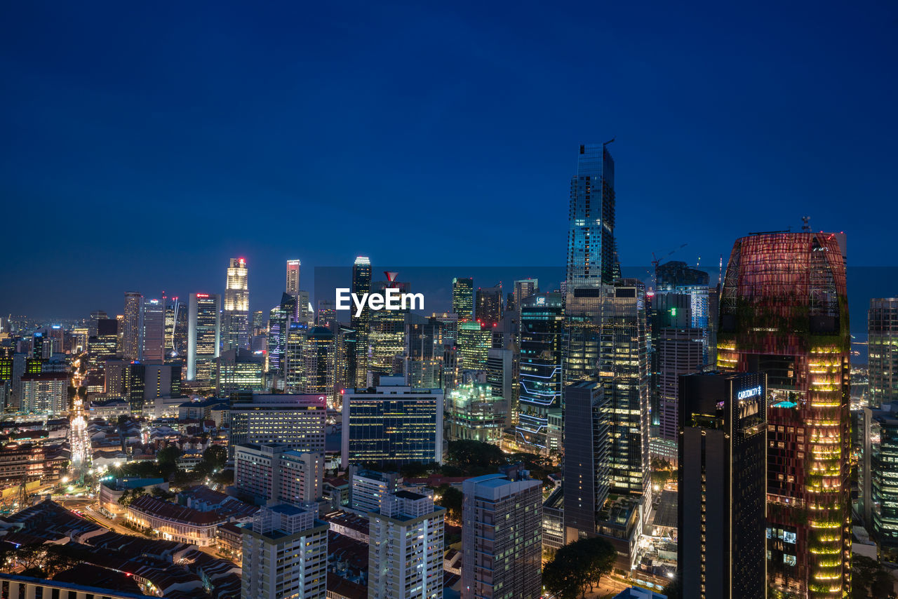 Aerial view of city lit up at night