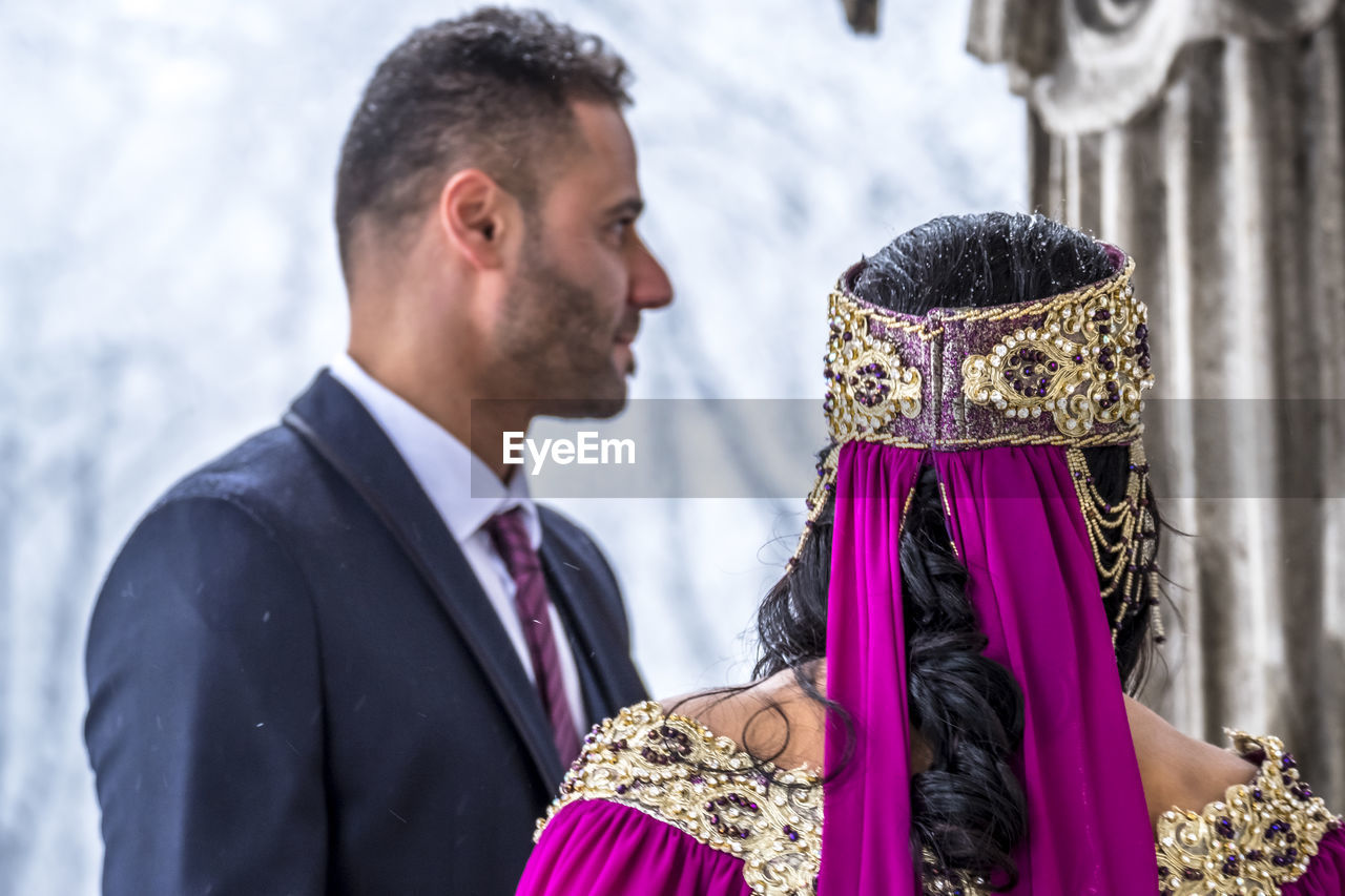 Rear view of bride with bridegroom during weeding ceremony