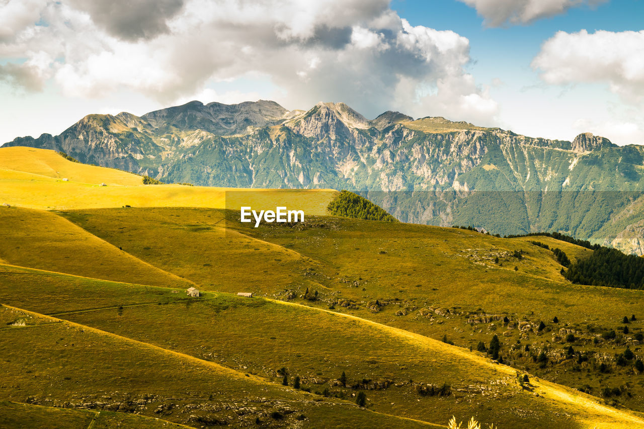 Scenic view of landscape against mountains and sky