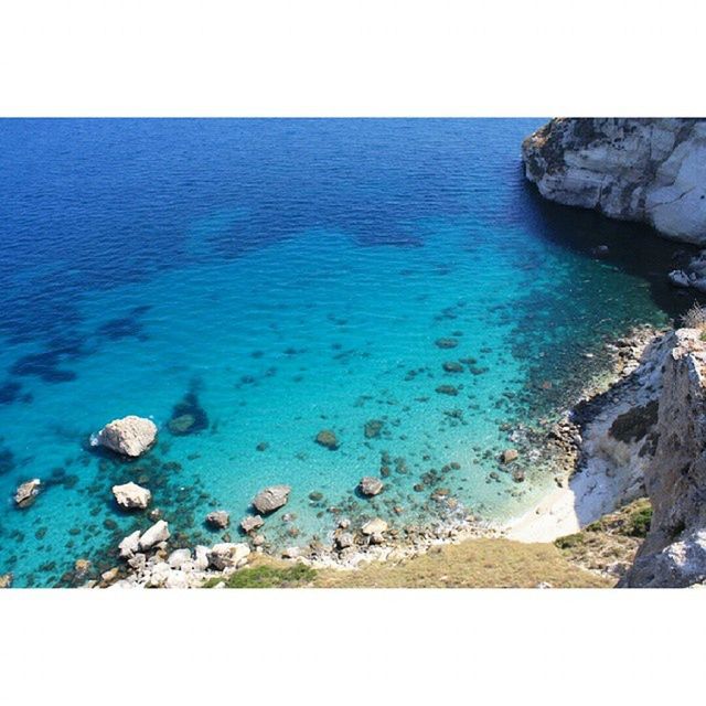 SCENIC VIEW OF SEA WITH ROCKS IN BACKGROUND