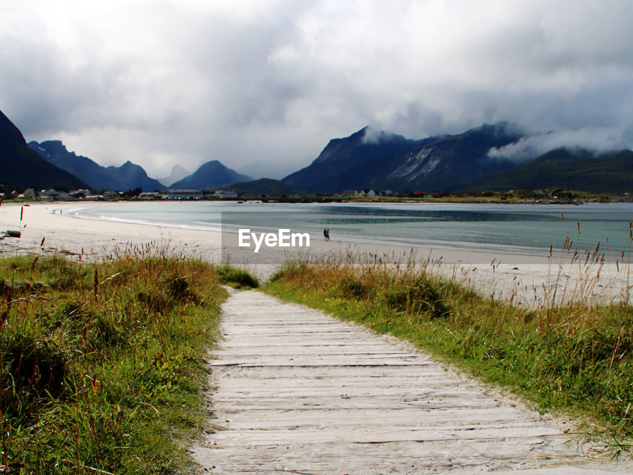 Scenic view of beach path and beach against sky