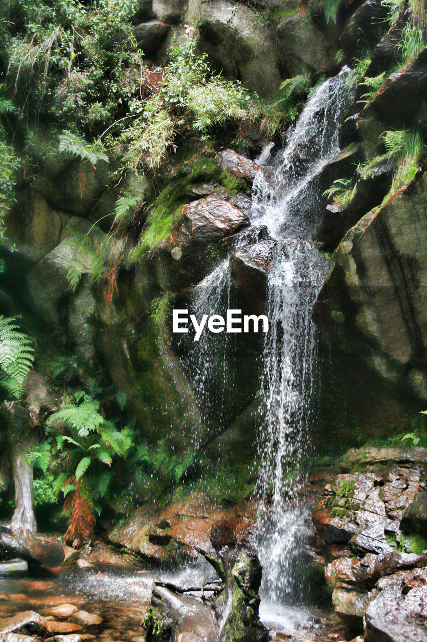 WATER FLOWING THROUGH ROCKS