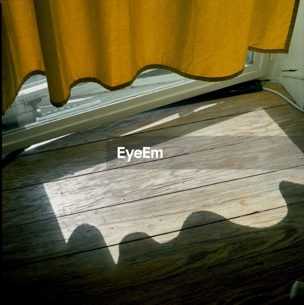 HIGH ANGLE VIEW OF PIANO KEYS WITH CURTAIN